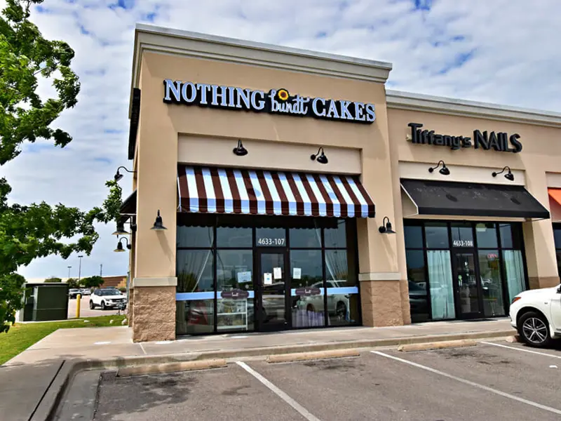 Exterior view of multiple buildings and parking areas apart of Central Texas Marketplace