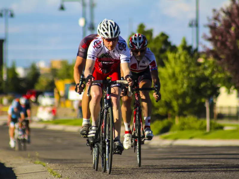 Cyclists riding on the road at dusk