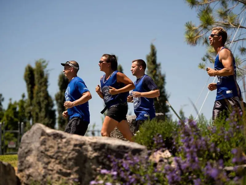 Group of 4 Ball Ventures team members running in race on sunny day