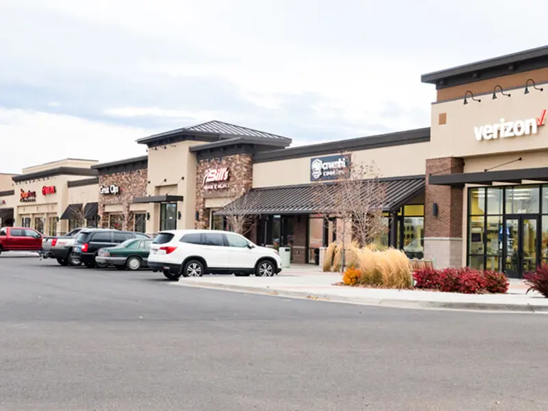 Exterior of multiple buildings and parking area at Sandcreek Commons