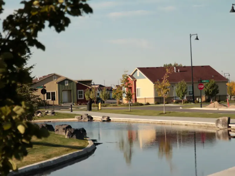 Far away exterior shot across a pond looking at apartments at Snake River Landing