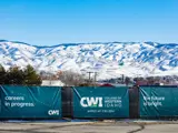 Exterior signs of the College of Western Idaho in front of a mountainous backdrop