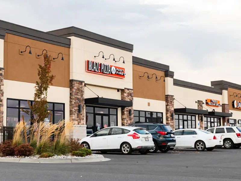 Exterior of multiple buildings and cars at Sandcreek Commons