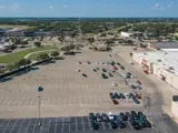 Exterior aerial view of parking lot and multiple buildings apart of Floor & Decor Mesquite