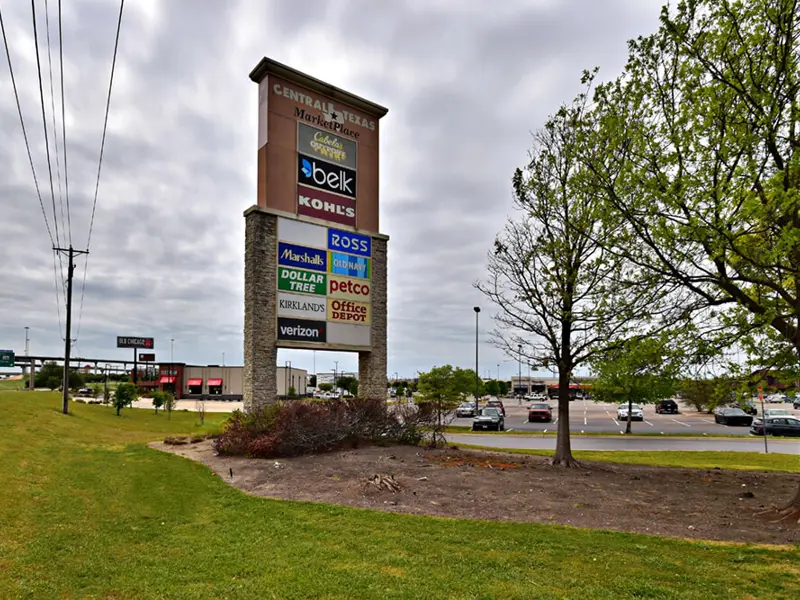 Exterior of multiple business signs on grassy road-facing area