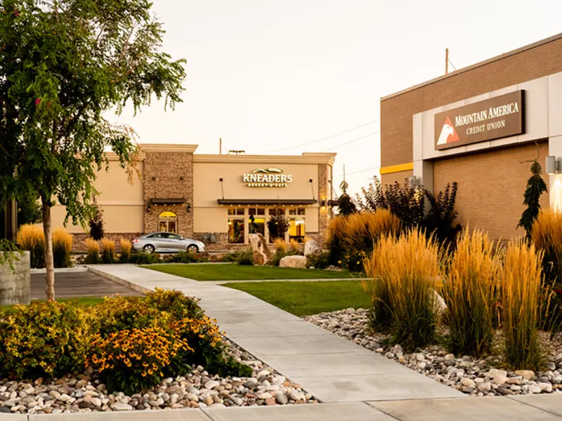 Exterior of multiple buildings and cars at Sandcreek Commons