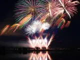 Night shot of multiple fireworks erupting from Snake River Landing during the Melaleuca Freedom Celebration