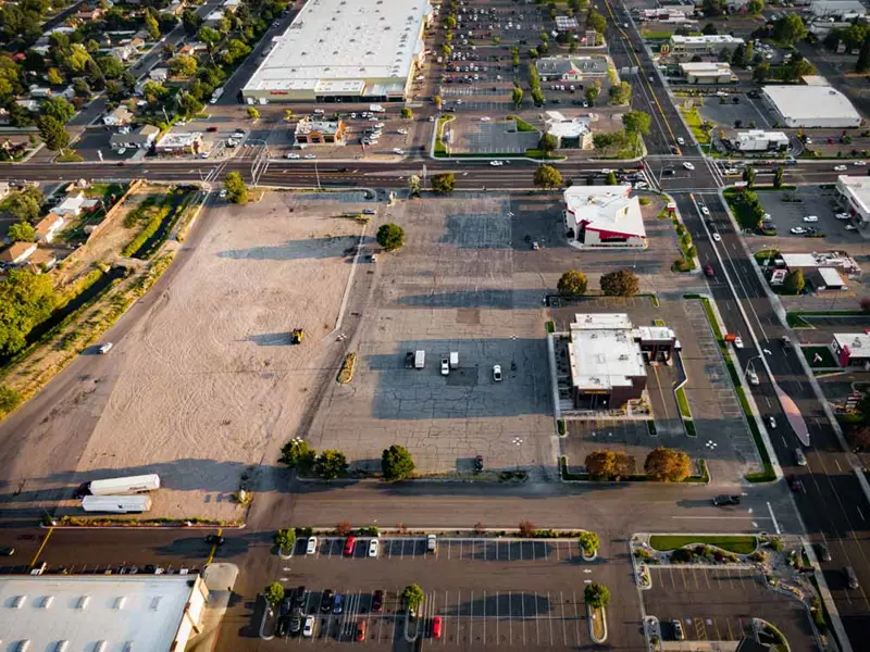 Exterior aerial view of building and parking area apart of Alameda Plaza