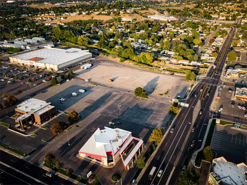 Exterior aerial view of buildings and parking area apart of Alameda Plaza