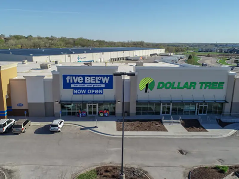Exterior aerial view of front of Dollar Tree, buildings and parking area apart of Wolf Creek Plaza