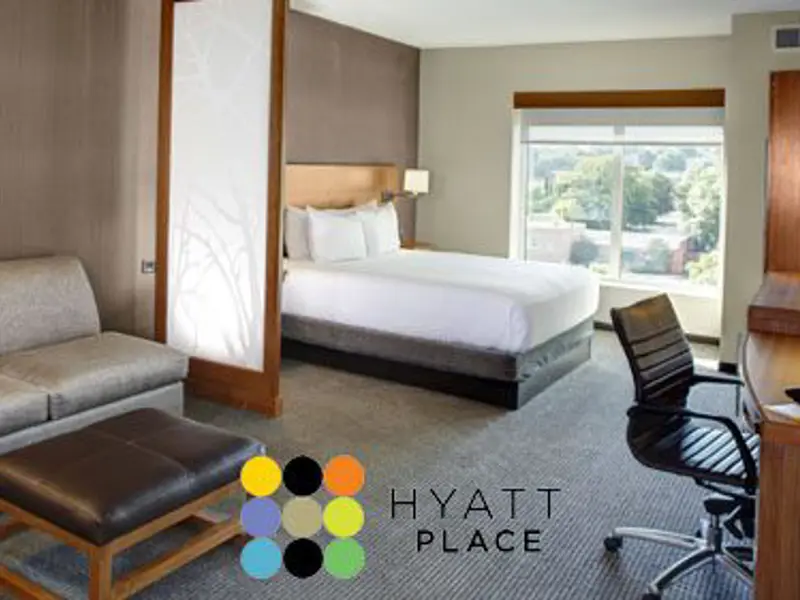 Interior of hotel room beds and couch at the Hyatt Place Fayetteville Springdale location