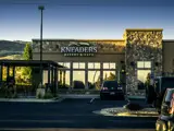 Exterior of Kneader's building at Center Pointe shopping center at dusk