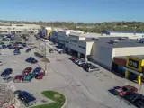 Exterior aerial view of front of multiple buildings and parking area apart of Wolf Creek Plaza