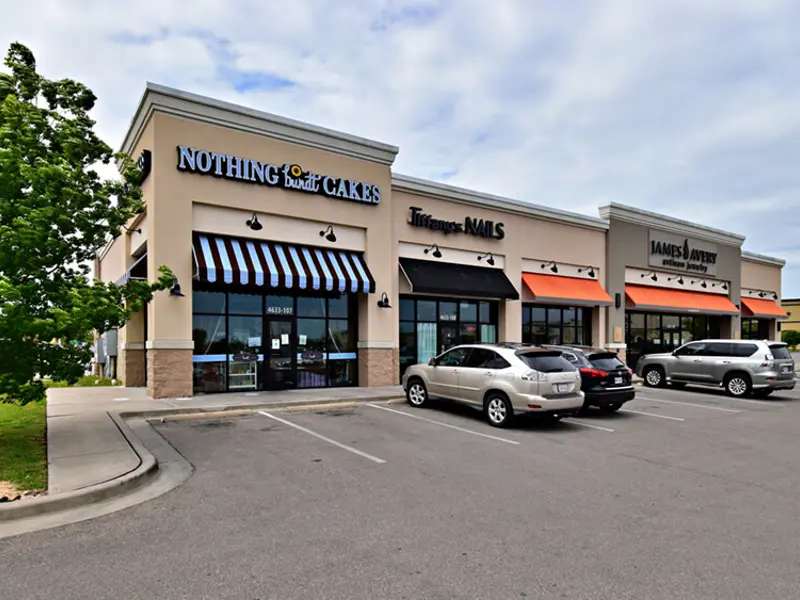 Exterior view of multiple buildings and parking areas apart of Central Texas Marketplace
